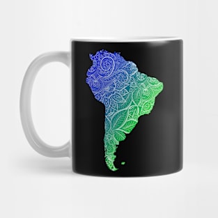 Colorful mandala art map of South America with text in blue and green Mug